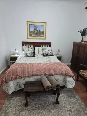 a bedroom with a large bed with pillows at Ilnika Farm Stay in Naboomspruit