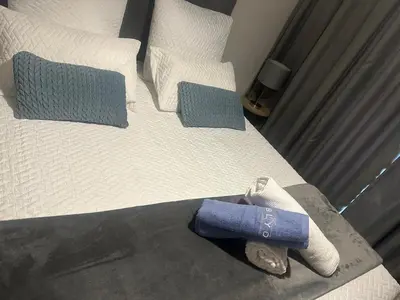 a bed with two pillows and towels on it at The Blyde Crystal Lagoon in Pretoria