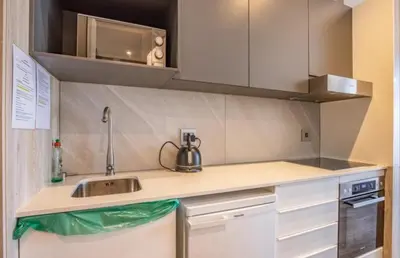 a kitchen with a sink and a microwave at Menlyn Maine Trilogy Apartment 611 in Pretoria