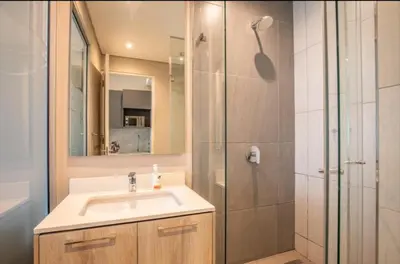 a bathroom with a sink and a shower at Menlyn Maine Trilogy Apartment 611 in Pretoria