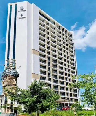 a large white building with a sign on it at Menlyn Maine Trilogy Apartment 611 in Pretoria