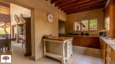 a kitchen with a counter and a clock on the wall at Zebula Golf and Wildlife Estate - Porcupine Strolling Pax 8 - Moi Signature Luxury villa in Mabula