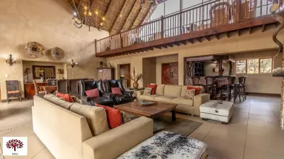 a large living room with couches and a table at Zebula Golf and Wildlife Estate - Porcupine Strolling Pax 8 - Moi Signature Luxury villa in Mabula