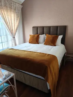 a large bed in a bedroom with a window at Unit 89 Pendleberry Holiday Resort in Bela-Bela