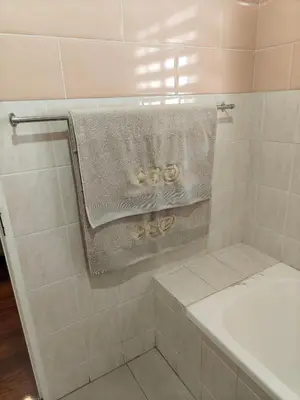 a bathroom with a shower with a towel and a sink at Unit 89 Pendleberry Holiday Resort in Bela-Bela