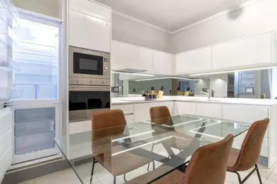 a kitchen with a glass table and chairs at #AlimamaSpaces: Jay's Cassini in Midrand