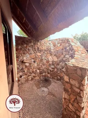 a stone building with a stone wall at Zebula Golf and Wildlife Estate - Nights Sky Pax 16 - Moi Signature Luxury villa in Mabula