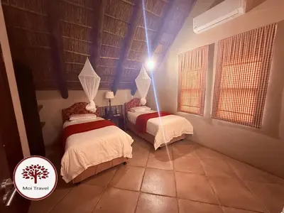 two beds in a room with a blue ceiling at Zebula Golf and Wildlife Estate - Nights Sky Pax 16 - Moi Signature Luxury villa in Mabula
