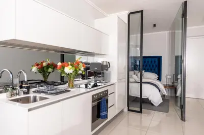 a white kitchen with a sink and a bed at Witshire Luxury apartment, Ellipse in Midrand