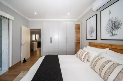 a bedroom with a large white bed in a room at Utopia on the Rock2 in Nelspruit