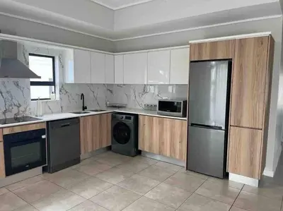 a kitchen with a stainless steel refrigerator and a dishwasher at Executive Penthouse in Midrand, Waterfall City - Fast WiFI and Secure Parking - 3 Elizabeth Place in Midrand