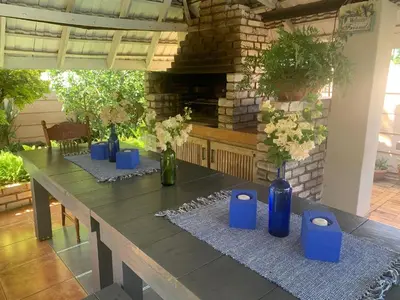 a long table with blue vases on top of it at Bougain Villa Guest House in Polokwane