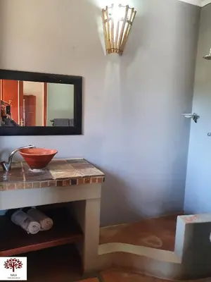 a bathroom with a sink and a mirror at Zebula Golf and Wildlife Estate - Kudu's Bark Pax 12 - Moi Signature Luxury villa in Mabula