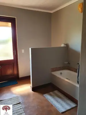 a bathroom with a bath tub in a room at Zebula Golf and Wildlife Estate - Kudu's Bark Pax 12 - Moi Signature Luxury villa in Mabula