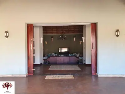 a living room with a purple couch in a room at Zebula Golf and Wildlife Estate - Kudu's Bark Pax 12 - Moi Signature Luxury villa in Mabula