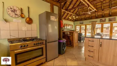 a kitchen with a stove and a refrigerator at Zebula Golf and Wildlife Estate - Walk of the Eland Pax 12 - Moi Signature Luxury villa in Mabula