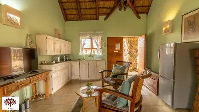 a kitchen with white cabinets and a refrigerator at Zebula Golf and Wildlife Estate - Walk of the Eland Pax 12 - Moi Signature Luxury villa in Mabula
