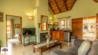 a living room with a couch and a table at Zebula Golf and Wildlife Estate - Walk of the Eland Pax 12 - Moi Signature Luxury villa in Mabula