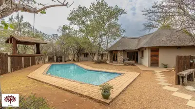 a house with a swimming pool in the yard at Zebula Golf and Wildlife Estate - Walk of the Eland Pax 12 - Moi Signature Luxury villa in Mabula