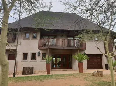 a large white house with a balcony on it at Zebula Golf and Wildlife Estate - Great Heights Pax 16 - Moi Signature Luxury villa in Mabula