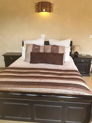a bedroom with a large bed with pillows at Zebula Golf and Wildlife Estate - Great Heights Pax 16 - Moi Signature Luxury villa in Mabula