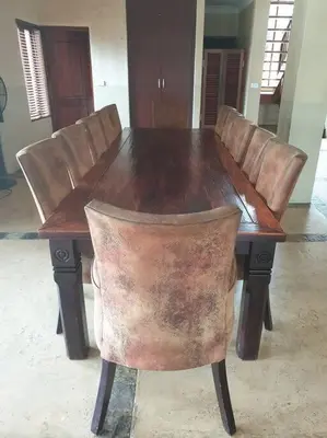 a wooden table with leather chairs around it at Zebula Golf and Wildlife Estate - Great Heights Pax 16 - Moi Signature Luxury villa in Mabula