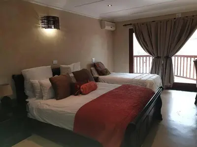 a hotel room with two beds in a room at Zebula Golf and Wildlife Estate - Great Heights Pax 16 - Moi Signature Luxury villa in Mabula