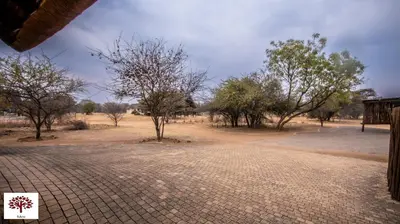 a dirt road in the middle of a field with trees at Zebula Golf and Wildlife Estate - Open Horizon Pax 8 - Moi Signature Luxury villa in Mabula