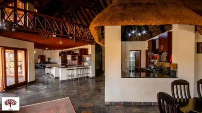 a kitchen and dining room with a table and chairs at Zebula Golf and Wildlife Estate - Open Horizon Pax 8 - Moi Signature Luxury villa in Mabula