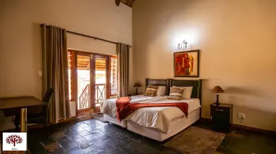 a bedroom with a bed and a window and a piano at Zebula Golf and Wildlife Estate - Open Horizon Pax 8 - Moi Signature Luxury villa in Mabula