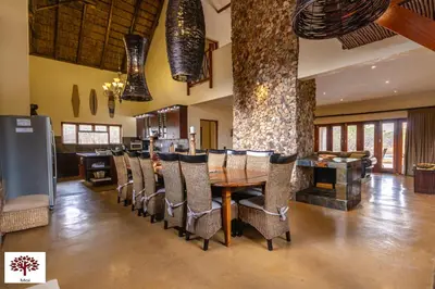 a dining room with a table and chairs at Zebula Golf and Wildlife Estate - Aardwolf Pax 10 - Moi Signature Luxury villa in Mabula