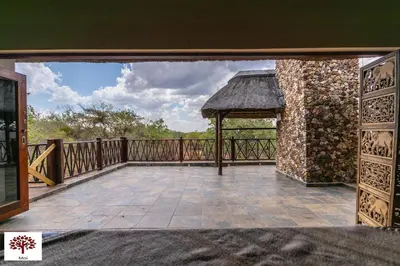 a balcony with a gazebo and a stone wall at Zebula Golf and Wildlife Estate - Aardwolf Pax 10 - Moi Signature Luxury villa in Mabula