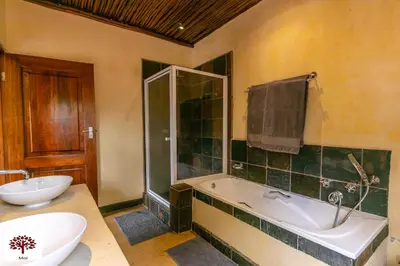 a bathroom with a tub and a sink at Zebula Golf and Wildlife Estate - Aardwolf Pax 10 - Moi Signature Luxury villa in Mabula