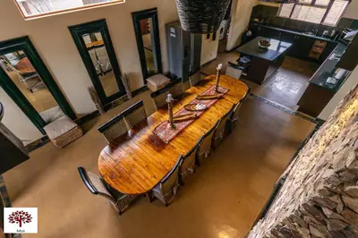 an overhead view of a wooden table and chairs at Zebula Golf and Wildlife Estate - Aardwolf Pax 10 - Moi Signature Luxury villa in Mabula