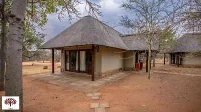 a small building with a thatched roof at Zebula Golf and Wildlife Estate - Oryx Walkway Pax 16 - Moi Signature Luxury villa in Mabula