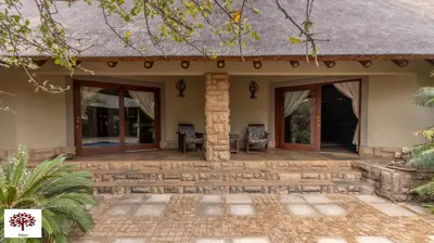 a patio of a house with sliding glass doors at Zebula Golf and Wildlife Estate - Oryx Walkway Pax 16 - Moi Signature Luxury villa in Mabula