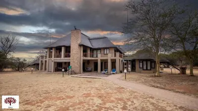 a house with a chimney on top of it at Zebula Golf and Wildlife Estate - Owl's Haven Pax 10 - Moi Signature Luxury villa in Mabula