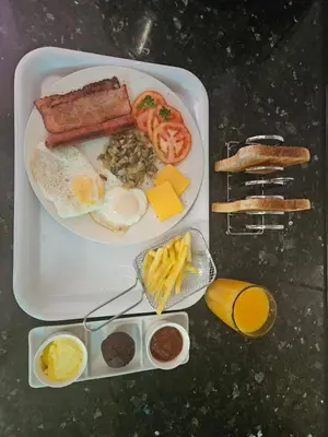 a tray with a plate of breakfast food on a table at Villa La Sola B&B and Self-Catering in Boksburg