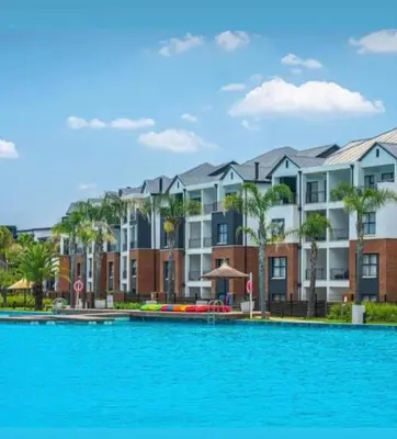 aominium building with a large pool in front of it at The Blyde Holiday beach in Pretoria