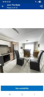 a living room with two chairs and a table at The Blyde Holiday beach in Pretoria