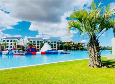 a palm tree next to a pool with a water park at The Blyde Holiday beach in Pretoria