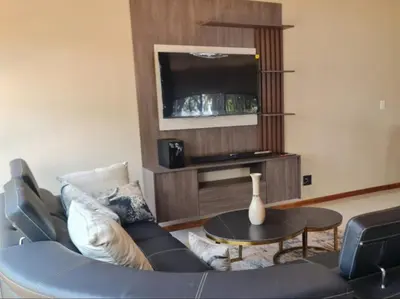 a living room with a couch and a tv at Tshifaro Gardens in Thohoyandou