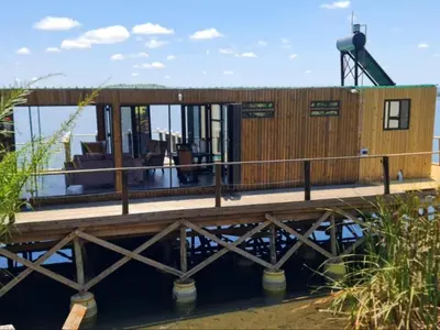 a house on a dock on the water at Tshifaro Gardens in Thohoyandou