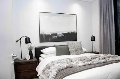 a bedroom with a bed and a painting on the wall at Epic Getaway in Waterfall in Midrand
