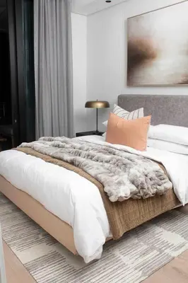 a bedroom with a large bed with a blanket at Epic Getaway in Waterfall in Midrand