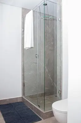 a glass shower in a bathroom with a toilet at Epic Getaway in Waterfall in Midrand