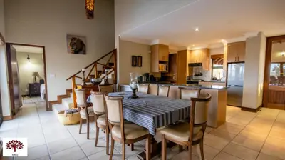 a kitchen and dining room with a table and chairs at Zebula Golf and Wildlife Estate - Open Plains Pax 10 - Moi Signature Luxury villa in Mabula
