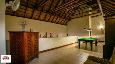 a room with a ping pong table in the middle at Zebula Golf and Wildlife Estate - Open Plains Pax 10 - Moi Signature Luxury villa in Mabula