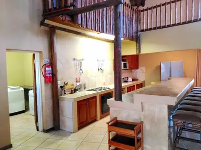a kitchen with a loft with a fire hydrant at Zebula Golf and Wildlife Estate - Njala Crossing Pax 13 - Moi Signature Luxury villa in Mabula