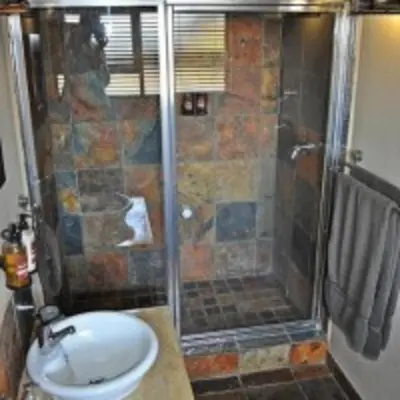 a bathroom with a shower and a sink at Zebula Golf and Wildlife Estate - Squirrel Pandemonium Pax 12 - Moi Signature Luxury villa in Mabula